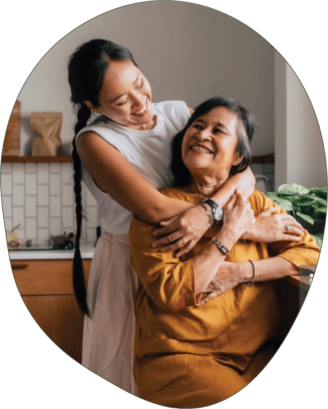 A photo of a mother and her adult child, the child is hugging her mother.