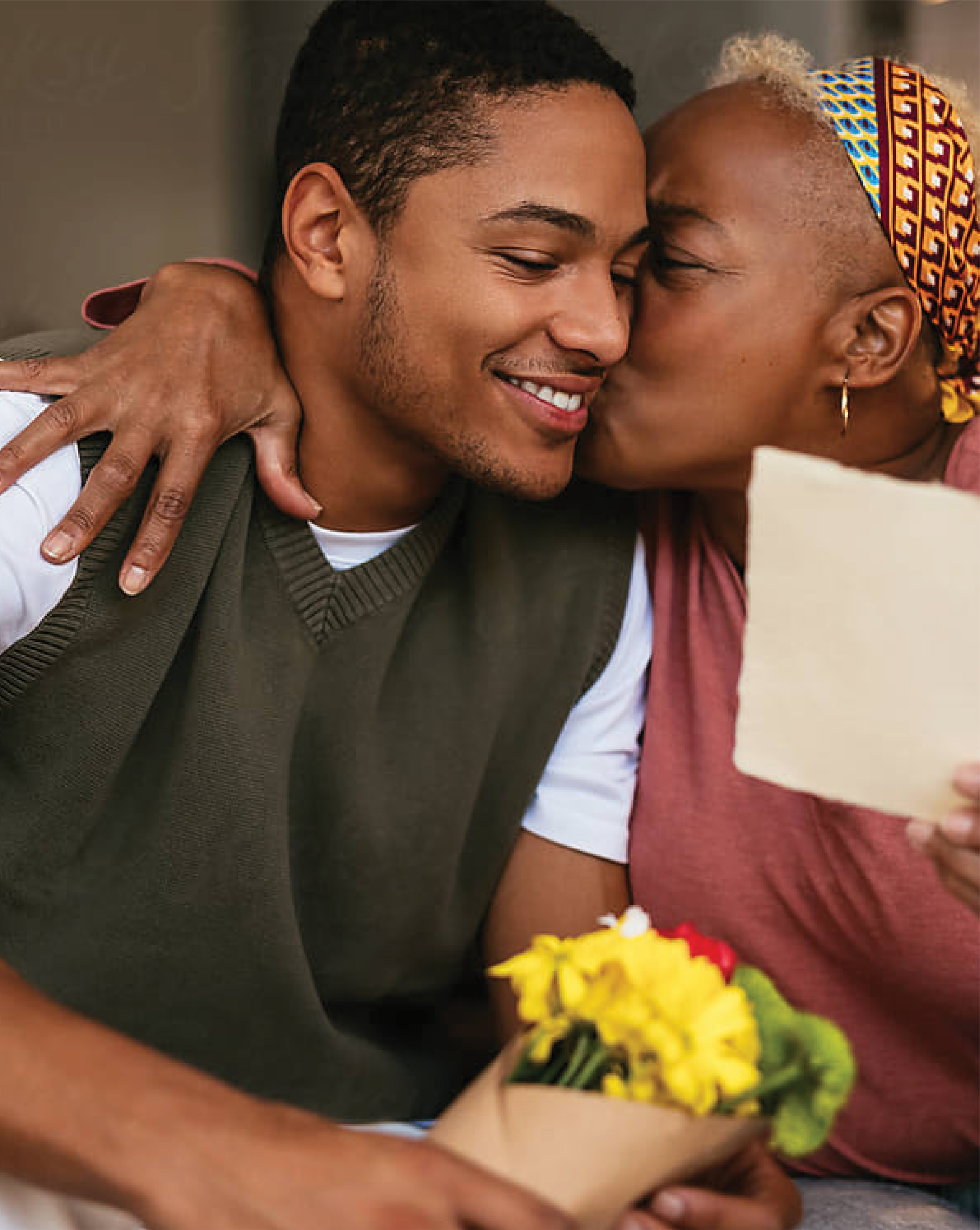 A photo of a mother and son embracing, the mother received a gift